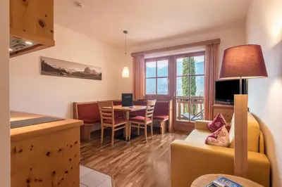a living room with a kitchen and a dining room at Appartements Riegelehof in Laion