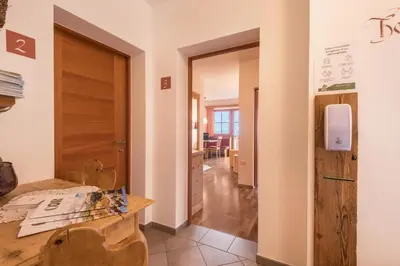 a room with a table and a hallway with a door at Appartements Riegelehof in Laion