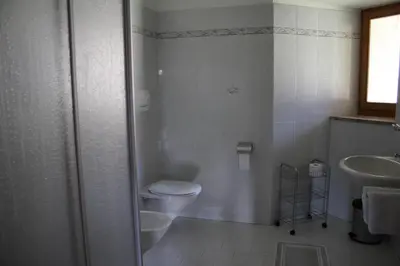 a bathroom with a toilet and a sink at Blummerhof in Lagundo