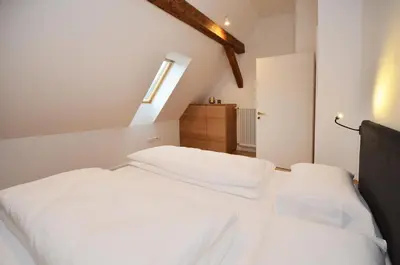 a bedroom with two white beds and a window at Aurturist Brunico in Brunico