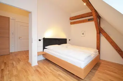 a bedroom with a large bed in a room at Aurturist Brunico in Brunico