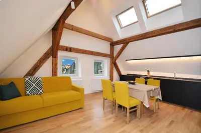 a living room with a yellow couch and a table at Aurturist Brunico in Brunico