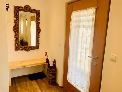 a room with a mirror and a window with a window curtain at Chalet Bernardi Apartments in Ortisei