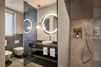 a bathroom with a sink and a mirror at Appius Design Suites B&B - ADULTS ONLY in Appiano sulla Strada del Vino