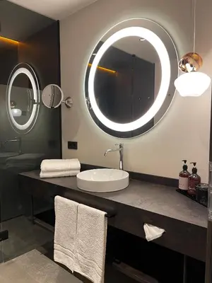 a bathroom with a sink and a large mirror at Appius Design Suites B&B - ADULTS ONLY in Appiano sulla Strada del Vino