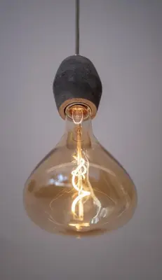 a glass light bulb hanging from a ceiling at Haus Lasaun in Bressanone