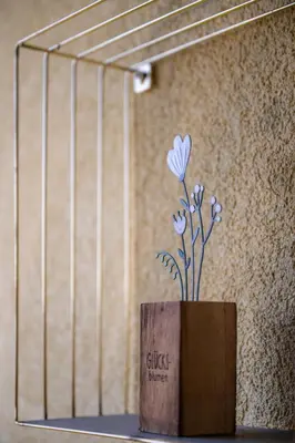 a vase with a flower in it on a shelf at Haus Lasaun in Bressanone