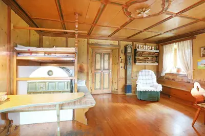 a room with bunk beds and a wooden floor at Hanslerhof in Braies