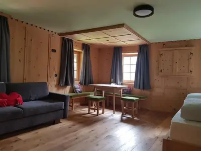 a living room with a couch and a table at Hanslerhof in Braies
