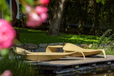 a pair of tan shoes sitting on a wooden deck at Garni Hotel Kessler in Tirolo