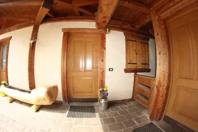 a room with a door and a chair in a house at Agriturismo Maso Fumas in Canale dʼAgordo