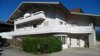 a large white house with a white balcony at Haus Schönblick in San Lorenzo di Sebato