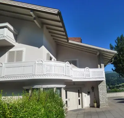 a white house with a balcony on it at Haus Schönblick in San Lorenzo di Sebato