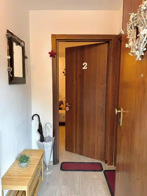 a wooden door with the number two on it in a room at Friedrich Apartments in Merano