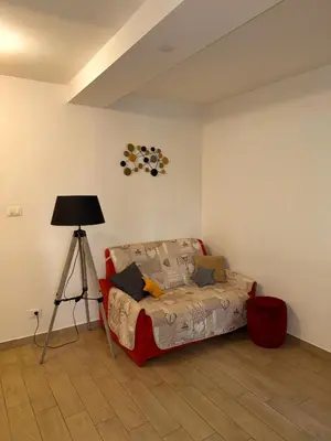 a room with a bed and a lamp and a tripod at Friedrich Apartments in Merano