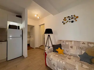 a living room with a couch and a refrigerator at Friedrich Apartments in Merano