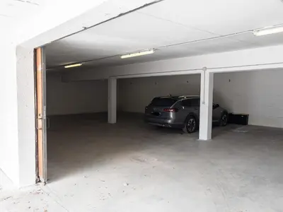 a parking garage with a car parked in it at Casa Ladinia in San Vito di Cadore