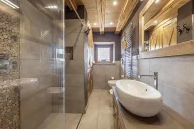 a bathroom with a sink and a shower at Casa Ladinia in San Vito di Cadore