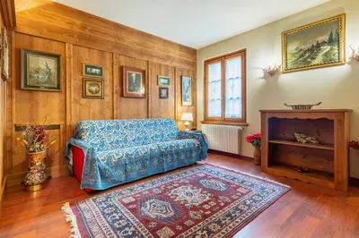 a living room with a couch and a fireplace at Villa S. Francesco - Stayincortina in Cortina dʼAmpezzo