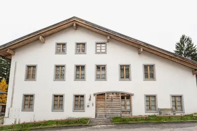 a white house with a gambrel roof at Villa S. Francesco - Stayincortina in Cortina dʼAmpezzo