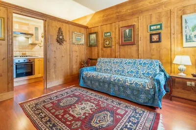 a living room with a couch and a rug at Villa S. Francesco - Stayincortina in Cortina dʼAmpezzo