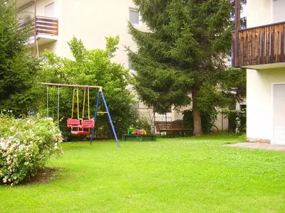 a playground with a swing in a yard at Residence Bichler in Merano