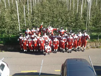 a group of people in red uniforms posing for a picture at Residence Bichler in Merano