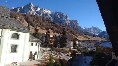 a window view of a patio with a table and chairs at Residence Ploner in San Cassiano