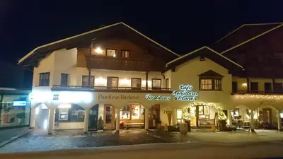 a large building with lights on it at night at Residence Ploner in San Cassiano