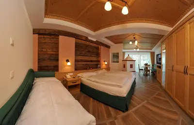 a bedroom with two beds in a room at Hotel Sureghes in Ortisei