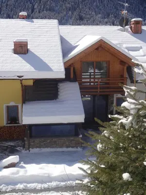 a house with snow on the roof at Chalet Residence Alpinflair in Ortisei