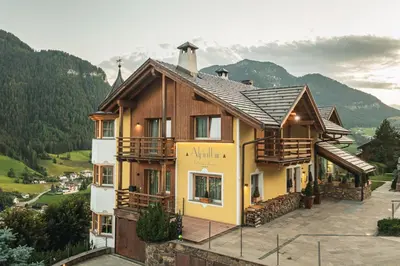 a house with a view of a mountain at Chalet Residence Alpinflair in Ortisei