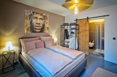 a bedroom with a bed with a painting on the wall at Il Florino in Merano