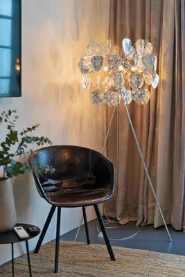 a black chair and a lamp in a room at Il Florino in Merano