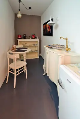 a kitchen with a table and a table and a chair at Il Florino in Merano