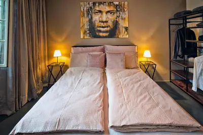 a bed in a room with a painting on the wall at Il Florino in Merano