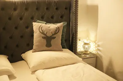 a bed with a pillow with a deer head on it at Il Florino in Merano