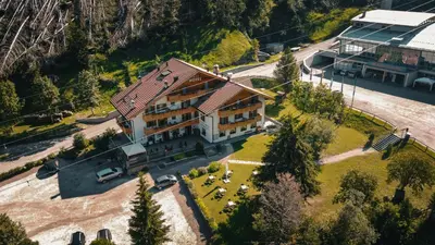 an aerial view of a large building with a yard at Hotel Malga Passerella in Moena