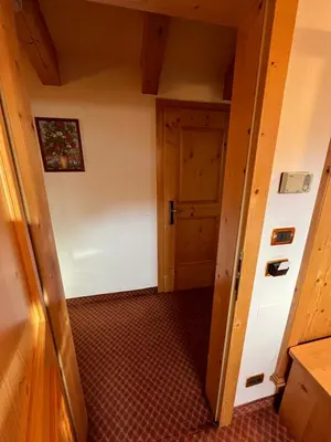 a hallway with a door in a room at Park Hotel Aurora in Pozza di Fassa
