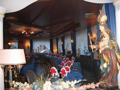 a dining room with blue tables with santa hats on them at Park Hotel Aurora in Pozza di Fassa