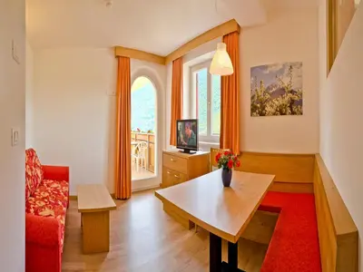 a living room with a table and a couch at Plarserhof in Lagundo