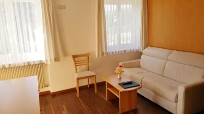 a living room with a couch and a table at Plarserhof in Lagundo