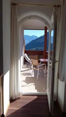 a balcony with chairs and a view of a mountain at Plarserhof in Lagundo