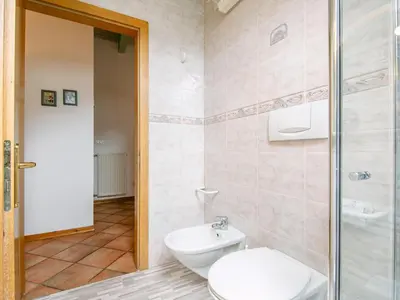 a hallway with a door and a tile floor at Apartment Cesa Pra da Molin-1 by Interhome in Campitello