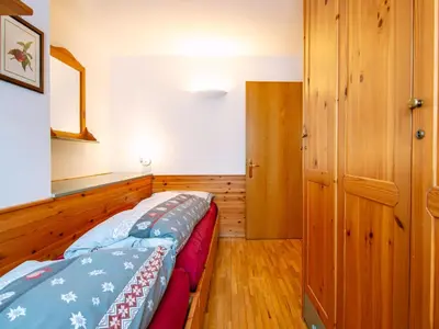 a bedroom with a bed and a wooden floor at Apartment Cesa Pra da Molin-2 by Interhome in Campitello