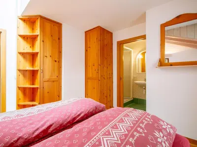 a bedroom with two beds with red sheets at Apartment Cesa Pra da Molin-4 by Interhome in Campitello