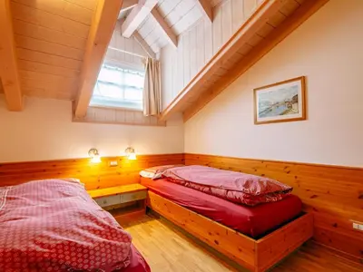 a bedroom with two beds and a window at Apartment Cesa Pra da Molin-4 by Interhome in Campitello