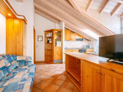 a dining room with a table and chairs and windows at Apartment Cesa Pra da Molin-4 by Interhome in Campitello