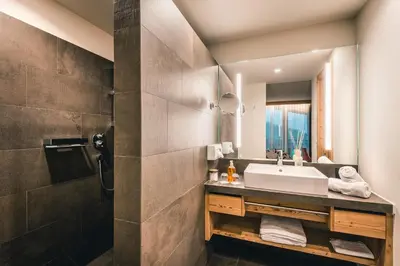 a bathroom with a sink and a shower at Dolasilla Mountain Panoramic Wellness Hotel in La Villa