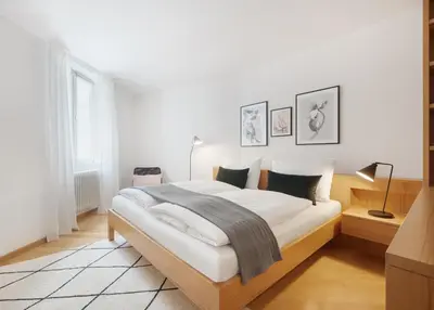 a white bedroom with a large bed in a room at Franciscus Apartments in Bolzano